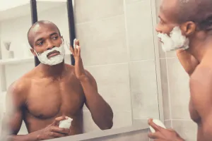 black man applying shaving cream