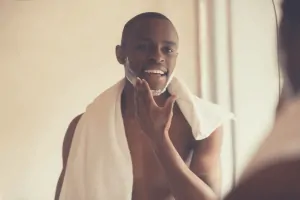 black man applying shaving cream