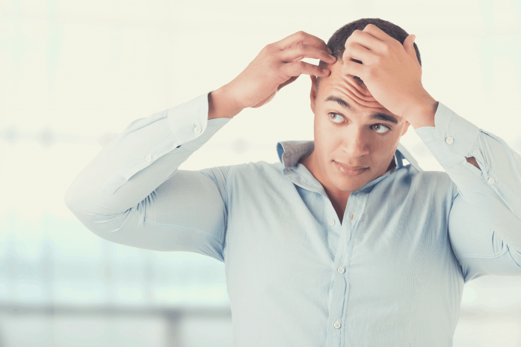 man checking hair