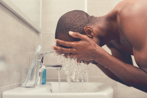 black man washing face