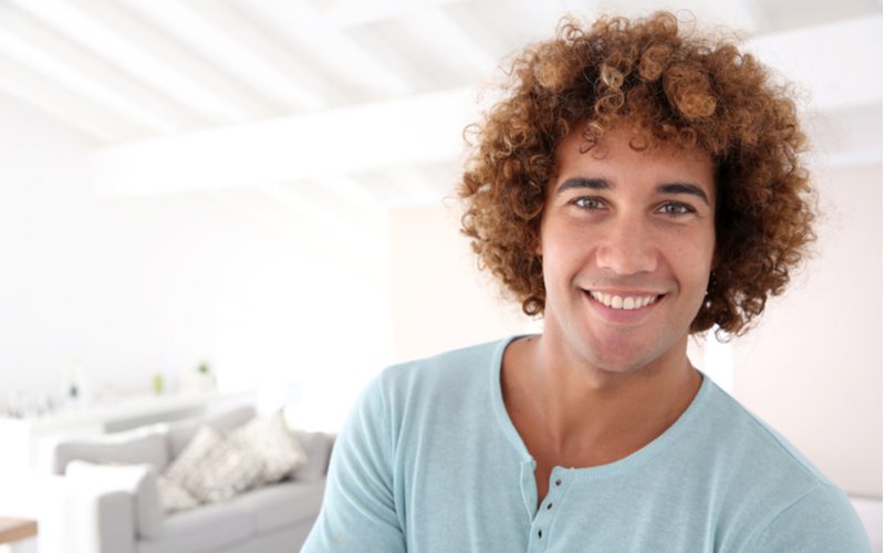 Fuzzy Curls on a man in a grey blue shirt
