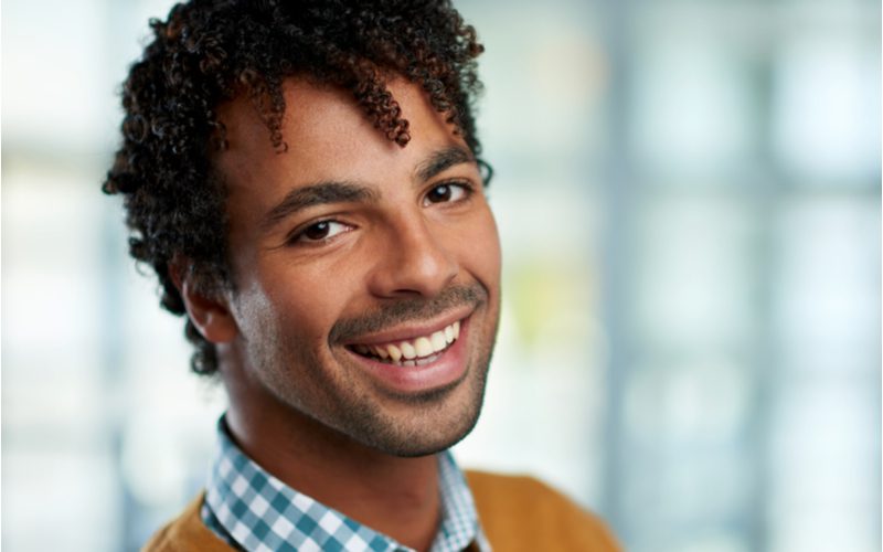 Corkscrew Bangs, a great hairstyle for curly hair men
